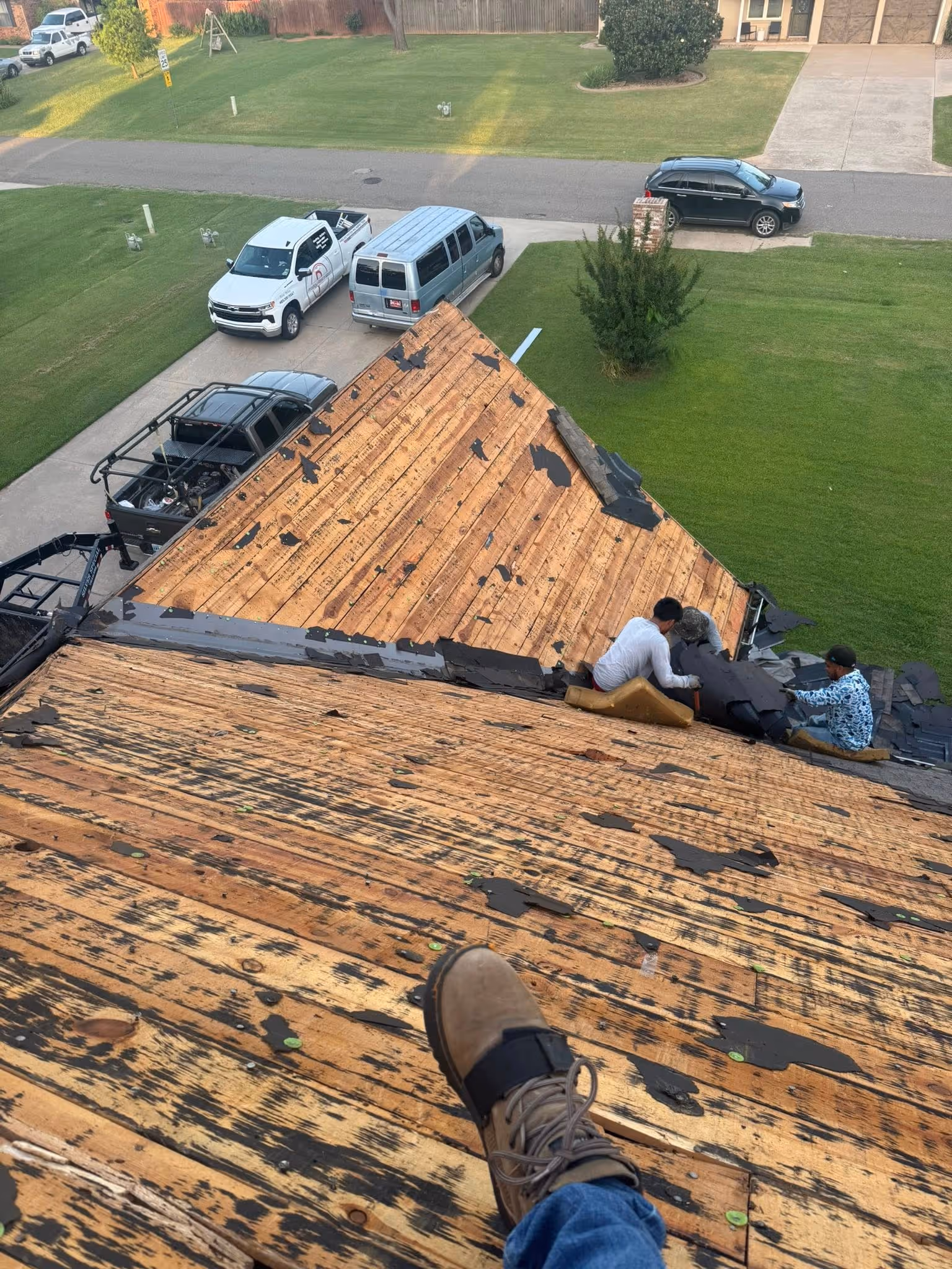 Roof torn off down to the wood decking during a replacement, seen from the roof.